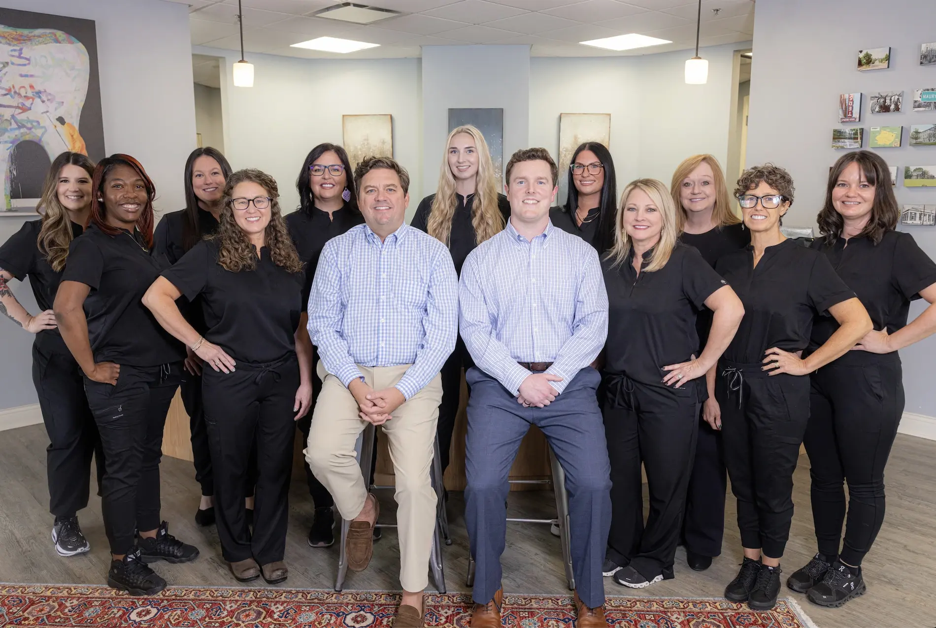 Dental practice team photo showing dentists and staff members smiling together in Columbia, TN office.